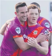  ??  ?? Linfield’s Andy Waterworth congratula­tes team-mate Shayne Lavery after his goal at Dungannon on Saturday