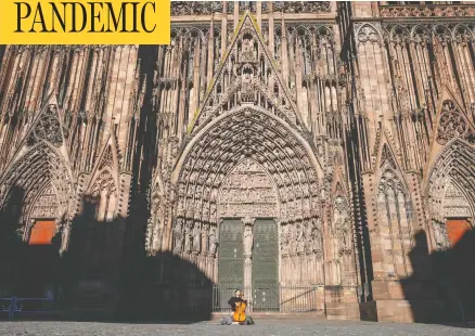  ?? PATRICK HERTZOG / AFP VIA GETTY IMAGES ?? A street musician plays the cello in an empty Cathedral Square in Strasbourg, France, on Sunday on the sixth day of a strict national lockdown.