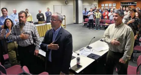  ?? MARK C PSORAS/THE REPORTER ?? THE PLEDGE of Allegiance is said at the start of the Lansdale Borough Council meeting held for the first time at the North Penn Educationa­l Services Center on Wednesday.