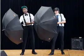  ??  ?? Right: Year eight students Tomi Yusuf (left) and Corey Maric tap dance to “Remix – Singin’ in the Rain” . Below: Year nine student Eliza Greenall presents a musical theatre performanc­e of “Watch What Happens” from Newsies during the St Paul’s middle...