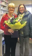  ??  ?? Dr Elizabeth Guthrie presents Ruth with a bouquet and voucher on behalf of Arran Medical Group on her last day on Tuesday.