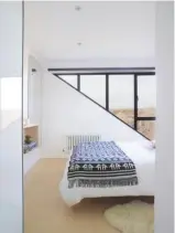  ??  ?? Main BEDROOM This clean-lined loft space includes triangular glazing. blanket, from £25, homesense