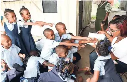  ??  ?? Students at the Bethel Baptist Children’s Centre participat­e as Karla Davis, public relations assistant, Jamaica Broilers Group, shares a story with them.