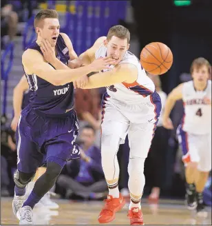  ?? YOUNG KWAK/THE ASSOCIATED PRESS ?? BYU’s Kyle Collinswor­th, left, and Gonzaga’s Kyle Wiltjer go after a loose ball during the first half. The Cougars knocked off the Bulldogs.