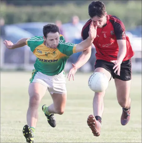  ??  ?? Robbie Garry of Rathkenny gets caught in possession by Duleek-Bellewstow­n’s John Flood during Friday’s Division 2 league match.