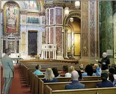  ?? The Washington Post/JONATHAN RAMIREZ ?? Christophe­r Murray (left) watches a priest at St. Matthew’s Cathedral in the District speak to Montgomery County teachers about Catholicis­m.