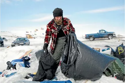  ?? PHOTO: REUTERS ?? Crystal Houser, of Klamath Falls, Oregon, collect blankets for delivery to nearby communitie­s while helping to clean up the protest camp against the Dakota Access oil pipeline near Cannon Ball, North Dakota yesterday.