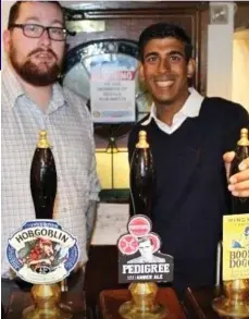  ??  ?? Called to bar: Rishi Sunak with landlord Michael Hunt