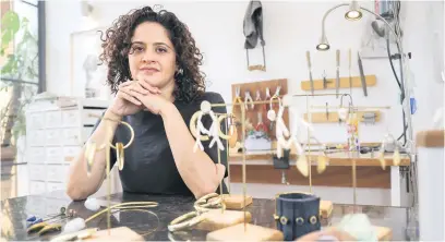  ?? Picture: AFP ?? CREATIVE. Kenyan designer Ami Doshi Shah with some of her eclectic jewellery pieces at her home studio, where she makes hand-made jewellery using locally sourced raw materials.
