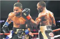  ?? JEFF ZELEVANSKY / GETTY IMAGES / AFP ?? Champion Terence Crawford nails Felix Diaz with a left hook during their WBO/WBC junior welterweig­ht title bout at Madison Square Garden on Saturday. Crawford improved to 31-0 when Diaz’s corner stopped the fight after the 10th round.