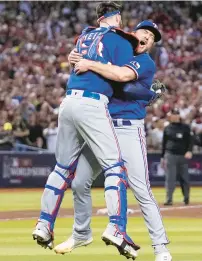  ?? BRYNN ANDERSON/AP ?? Texas relief pitcher Josh Sborz, right, and catcher Jonah Heim celebrate after the Rangers won Game 5 to clinch the World Series on Wednesday night. Sborz, a former UVA star, pitched 2.1 scoreless innings to earn the save and struck out Ketel Marte to end it.