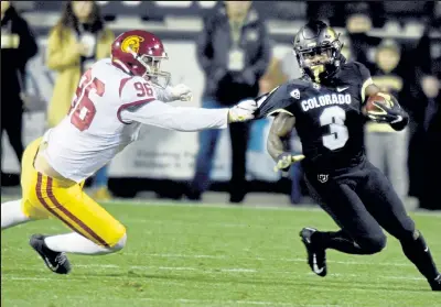  ?? Cliff Grassmick / Staff Photograph­er ?? Colorado receiver KD Nixon gets around USC’S Caleb Tremblay on Oct. 25.