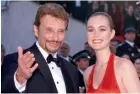  ??  ?? A file photo of Johnny Hallyday ( left) with his wife Laeticia at the 62nd Cannes. A fan shows his Johnny Hallyday replica jewels at his home in France on Tuesday.