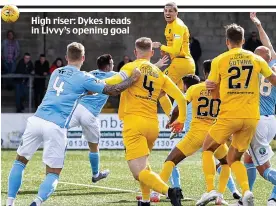  ??  ?? High riser: Dykes heads in Livvy’s opening goal