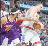  ?? David Zalubowski The Associated Press ?? Nuggets center Nikola Jokic, right, fights for control of a rebound in a game dominated by Denver.