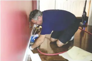  ??  ?? Having your home’s air ducts cleaned profession­ally is the best option, since technician­s like this have the proper equipment — adapters and brushes like the so-called whipper that spins and turns inside the duct “to wake up the sleeping dirt” which is sent directly to the vacuum.