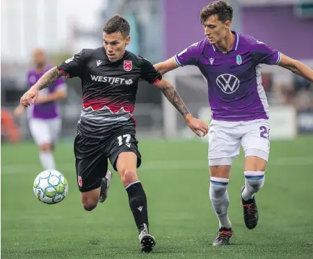  ?? DARREN STONE, TIMES COLONIST ?? Cavalry FC’s Ben Fisk, left, tries to fend off Pacific FC’s Sean Young during CPL action at Starlight Stadium on Friday.