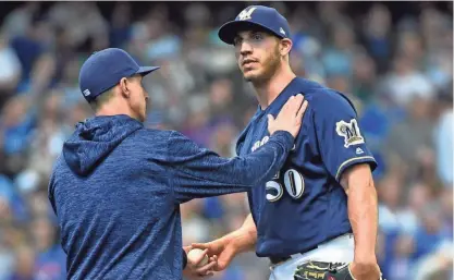  ?? BENNY SIEU / USA TODAY SPORTS ?? Milwaukee Brewers pitcher Jacob Barnes gets a pat from manager Craig Counsell after being relieved in the ninth inning during the game against the Chicago Cubs on Saturday.