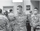  ?? CALEB JONES/AP ?? A National Guard member takes the temperatur­e of another arriving at the internatio­nal airport in Honolulu on April 21.