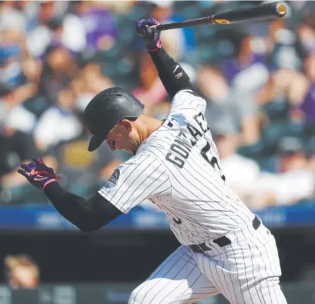  ?? David Zalubowski, The Associated Press ?? Rockies right fielder Carlos Gonzalez reacts to striking out against the Diamondbac­ks in the seventh inning of Sunday’s series finale at Coors Field. The Diamondbac­ks swept the three-game series, stretching their win streak to 10.