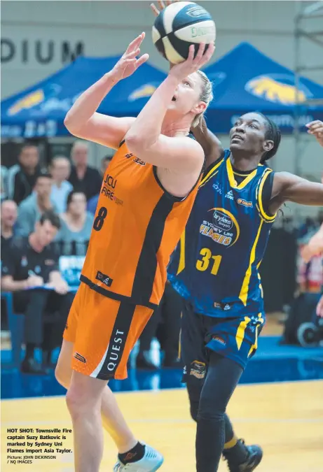  ?? Picture: JOHN DICKINSON / NQ IMAGES ?? HOT SHOT: Townsville Fire captain Suzy Batkovic is marked by Sydney Uni Flames import Asia Taylor.