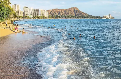  ?? MARCO GARCIA THE NEW YORK TIMES FILE PHOTO ?? Waikiki beach is seen in Honolulu, Hawaii, in September 2014. Visitors have been spotted on beaches breaking stay-at-home orders and quarantine restrictio­ns.