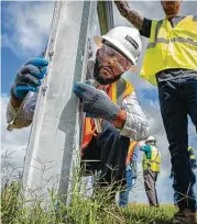  ?? Mark Mulligan / Staff photograph­er ?? A solar panel is installed during a training class at a solar farm south of El Campo in May.