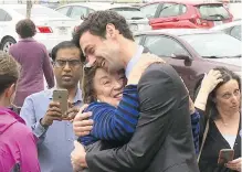  ??  ?? A supporter hugs Democratic Congressio­nal candidate Jon Ossoff in Roswell, Georgia, late last month.