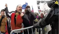  ?? METROPOLIT­AN POLICE DEPARTMENT/AP ?? This still frame from body camera video shows former New York City policeman Thomas Webster, second left, at a barricade line on Jan. 6 at the U.S. Capitol. Webster is accused of assaulting an officer with a flagpole.