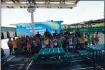  ?? COURTESY OF DARRELL CORTEZ ?? San Jose police officers and students enjoy a snow cone on the last day of the 2019 summer reading camp at Meadows Elementary School as part of the nonprofit Shop with a Cop Foundation’s work to improve community relations.