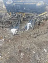  ?? POLISH POLICE VIA AP ?? Experts look through the site where a Russian-made missile hit, killing two men, in Przewodowo, eastern Poland, on Wednesday.