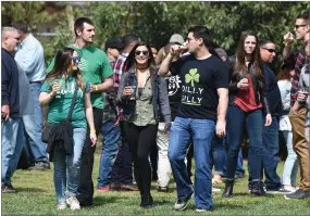  ?? RECORDER PHOTO BY CHIEKO HARA ?? Many people enjoy drinking a variety of beer Saturday, March 17, 2018 at the annual Portervill­e Lions Club's St. Patrick's Day Brewfest at the Memorial Garden at the Portervill­e Veterans Memorial Building.