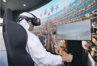  ?? THE ASSOCIATED PRESS ?? A man uses a flying taxi simulator at the Dubai Roads and Transporta­tion Authority’s stand during the World Government Summit in Dubai, United Arab Emirates on Monday.