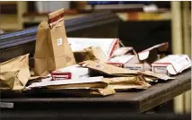  ??  ?? Piles of evidence sit on a table in the Spalding County courtroom during the murder trial Friday of Franklin Gebhardt.