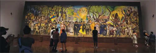  ?? ?? Visitors look at the “Dream of a Sunday afternoon in Alameda Central Park” mural by Mexican artist Diego Rivera at the Diego Rivera Mural Museum in Mexico City.*