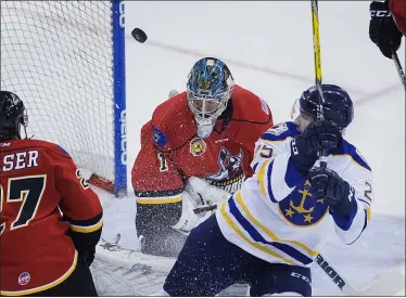  ?? L. TODD SPENCER — THE ASSOCIATED PRESS ?? A shot by Norfolk Admirals’ Alex Pompeo (25), right, deflects up into the air off Adirondack Thunder’s goalie J.P. Anderson (1) during the first period of an ECHL game Jan. 4, 2017, in Norfolk, Va.