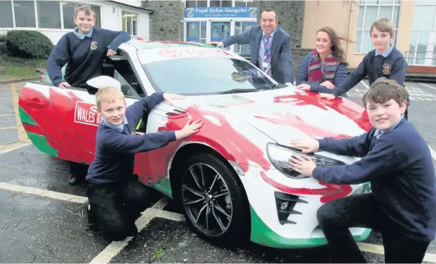  ??  ?? 12 year old Rheinallt Jones of Ysgol Gyfun, Llangefni, has won ‘Design a Rally Car Livery’ for Wales Rally GB. From left, pupils Morgan Goulding, Llyr Morgan Jones, Clive Thomas headmaster, Gwenno Williams, Charlie Hughes and Rheinallt Jones, winner of...