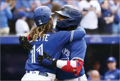  ?? JON BLACKER — THE CANADIAN PRESS VIA AP ?? Toronto Blue Jays’ Vladimir Guerrero Jr, right, and teammate Bo Bichette (11) celebrate Guerrero’s two-run home run against the Boston Red Sox.