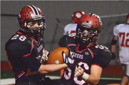  ?? Eric Bonzar/EBonzar@MorningJou­rnal.com ?? St. Paul’s Jim Easler (28) celebrates his intercepti­on returned for a touchdown with teammate Nate Meyer on Nov. 29. The Flyers defeated the Trimble Tomcats, 41-13, to advance to the Division VII state final on Dec. 6 in Columbus.