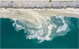  ?? (Photo/IC Photo) ?? A drone photo shows mucilage (sea snot) continuing to cover the surface of Marmara Sea at the Caddebosta­n shore in Istanbul, Turkey on June 25, 2021.