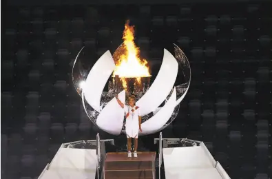  ?? Laurence Griffiths / Getty Images ?? Tennis Grand Slam champion Naomi Osaka lit the Olympic cauldron to cap Friday’s Opening Ceremony.