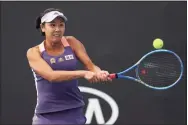  ?? Clive Brunskill / TNS ?? China’s Shuai Peng plays a backhand during a doubles match in the first round of the Australian Open in 2020.