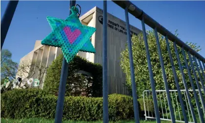  ?? Photograph: Gene J Puskar/AP ?? A Star of David hangs from a fence outside the dormant landmark Tree of Life synagogue in Pittsburgh's Squirrel Hill neighborho­od.