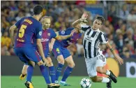  ?? — AFP ?? Barcelona’s Andres Iniesta vies with Juventus’ Paulo Dybala. Barcelona beat Juventus 3-0.