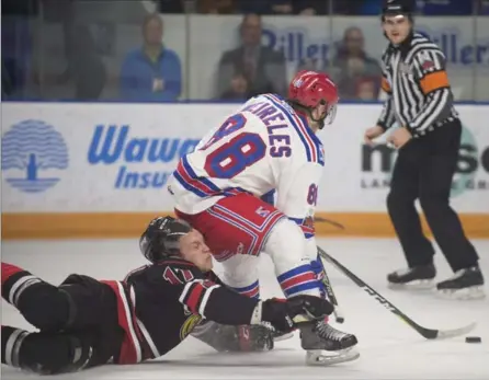  ?? PETER LEE, RECORD STAFF ?? Trenton Bourque, left, of the Owen Sound Attack falls and has his helmet come off as he checks Rangers’ Greg Meireles at the Aud on Friday.