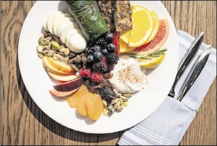  ?? CONTRIBUTE­D BY MIA YAKEL ?? Mediterran­ea’s Mediterran­ean Breakfast includes fresh fruit, dried fruit, nuts, dolmas, hard-cooked egg, yogurt , fig compote, and seasoned bread.