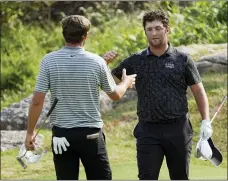  ?? DAVID J. PHILLIP — THE ASSOCIATED PRESS ?? Jon Rahm, of Spain, right, congratula­tes Scottie Scheffler on the 17th green after Scheffler won their round of eight match at the Dell Technologi­es Match Play Championsh­ip on Saturday in Austin, Texas.