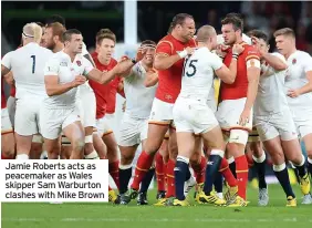  ?? ?? Jamie Roberts acts as peacemaker as Wales skipper Sam Warburton clashes with Mike Brown