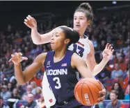  ?? John Minchillo / Associated Press ?? UConn’s Megan Walker (3) looks to pass while defended by Dayton’s Julia Chandler (13) on Tuesday.