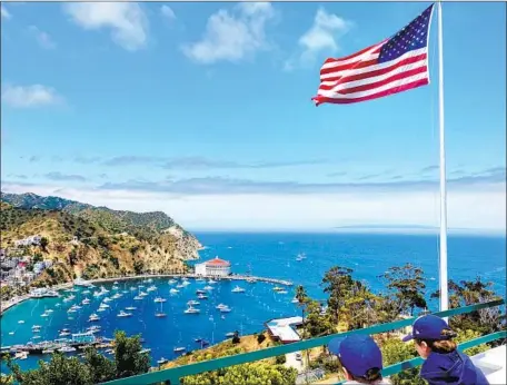  ?? Photograph­s by Paul Boorstin ?? THE WRITER’S grandsons soak in the view of Catalina’s Avalon Bay from Mt. Ada., home of onetime island owner William Wrigley Jr.